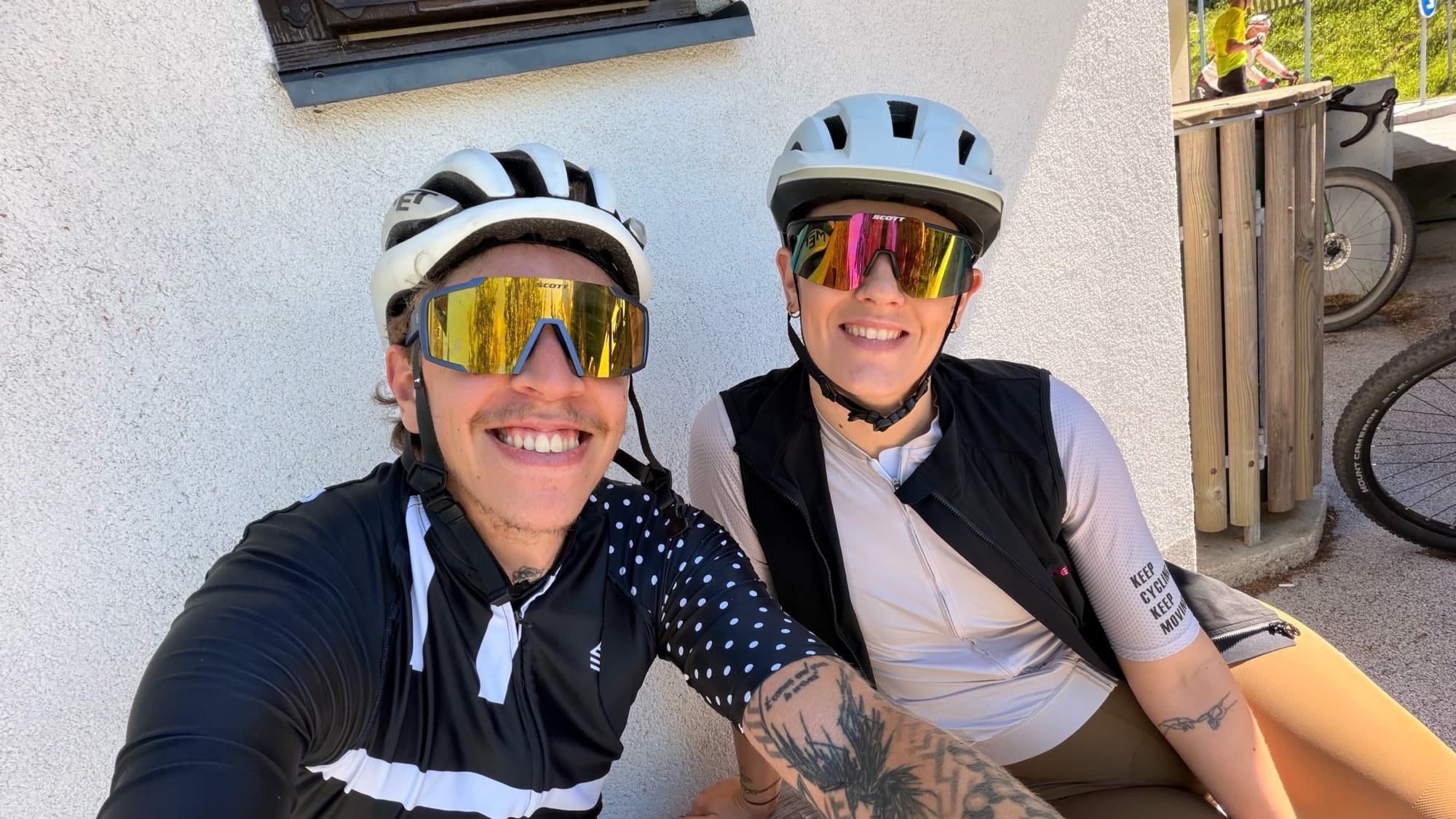 Selfie of Bor and wife in helmets and mirrored sunglasses, smiling during a break on a ride.